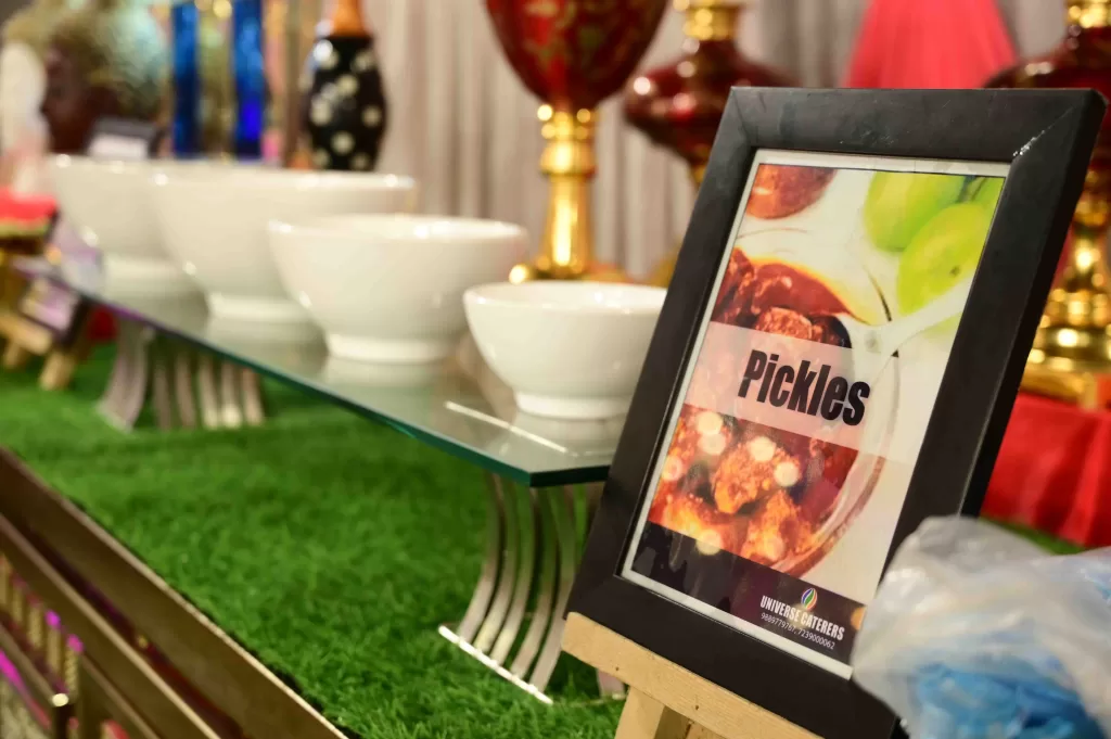Traditional pickle counter setup by best veg caterers in Sonbhadra for wedding catering services.